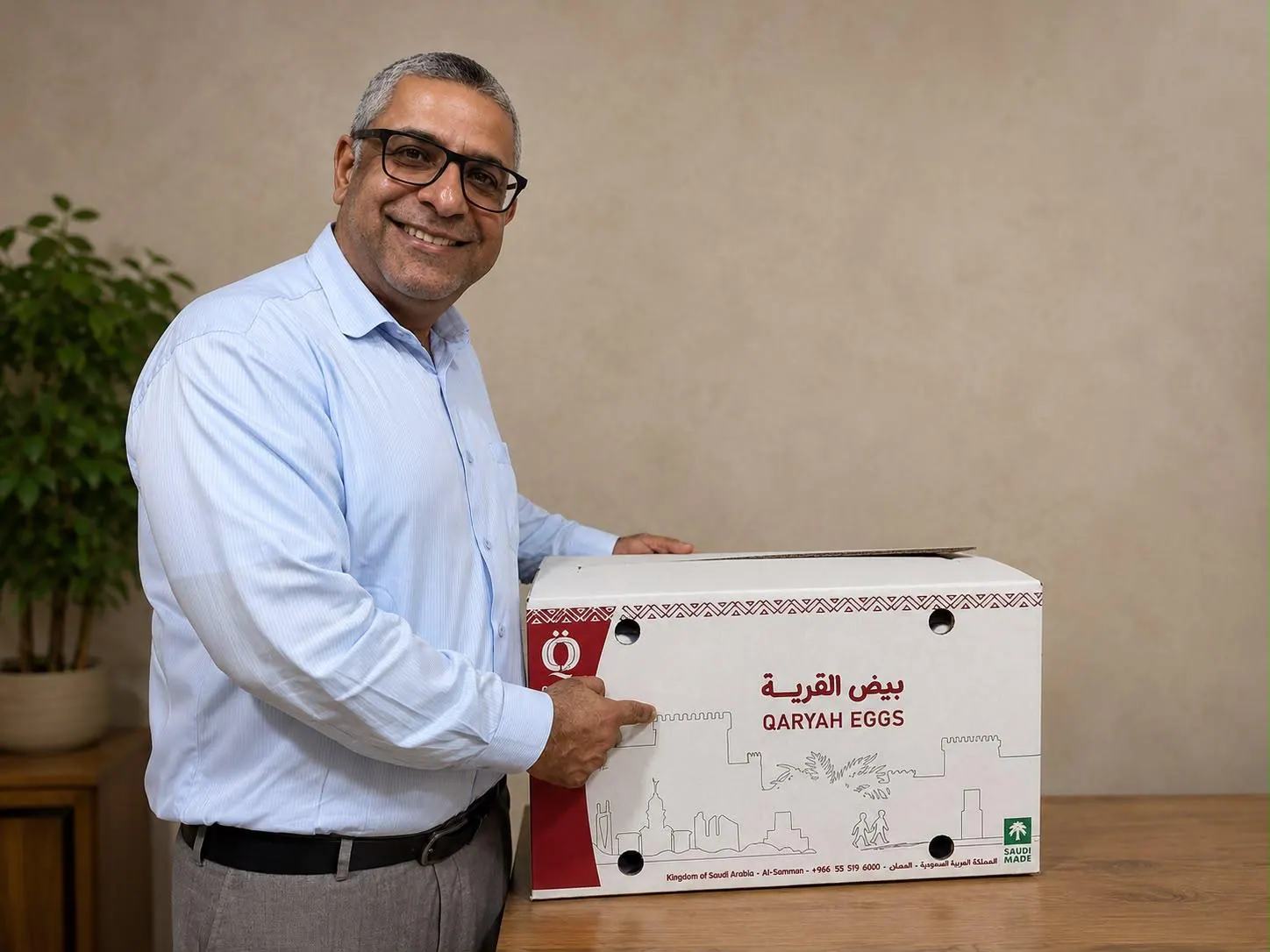 Noor Al Rizq team member with a carton of fresh eggs for hotel and restaurant supply in Bahrain